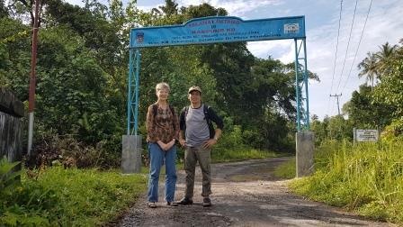 Mary and Wayan at a village gate